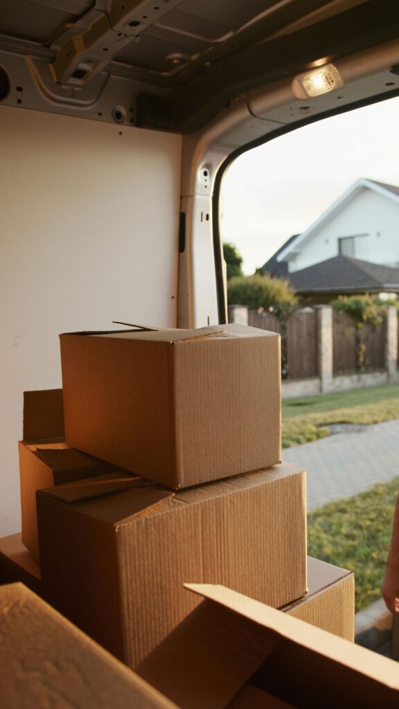 pexels-photo-5025512-5025512 View inside a delivery van with stacked cardboard boxes ready for moving.